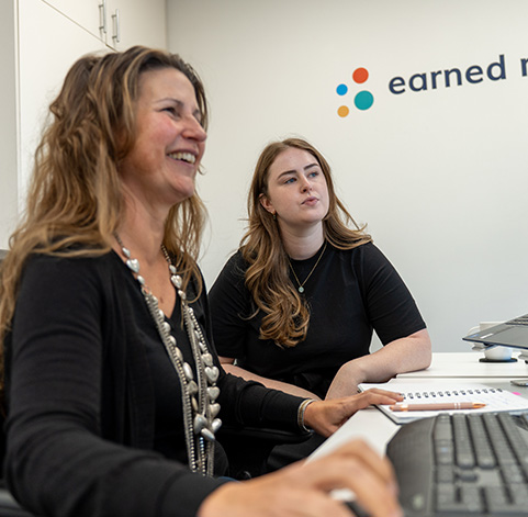 Earned Media team reviewing AI visibility data